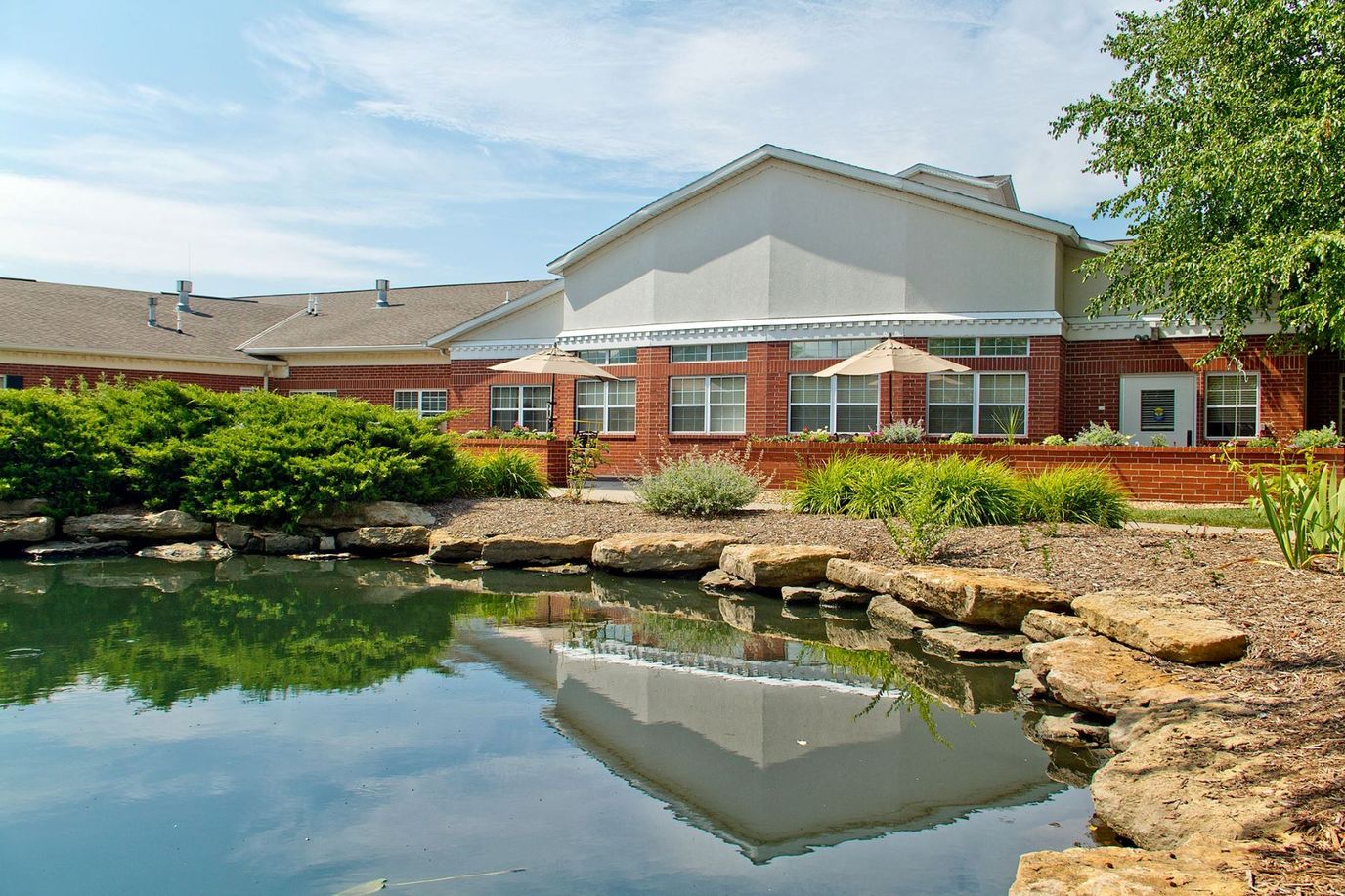 Exterior view of the facility alongside a pond