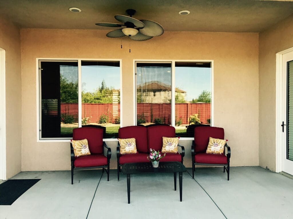 Outdoor seating area with red chairs and a small table