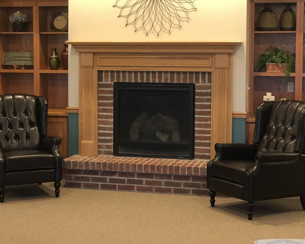 Cozy seating area with a fireplace and bookshelves