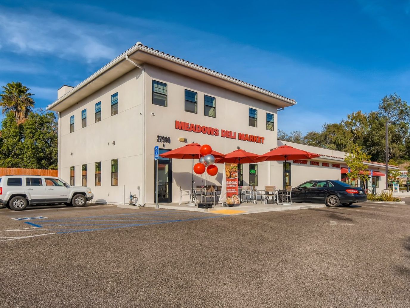 Exterior view of a market building with outdoor seating