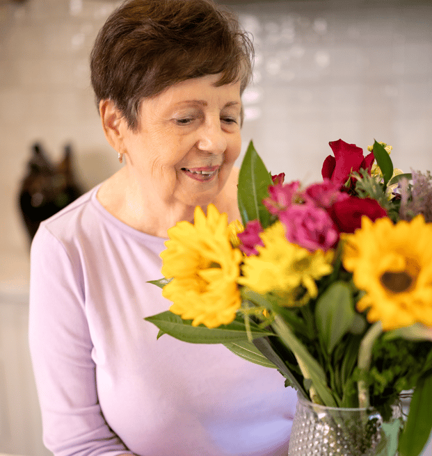 Resident arranging a colorful bouquet of flowers