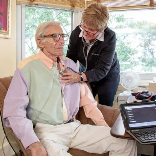Healthcare worker assisting a resident indoors
