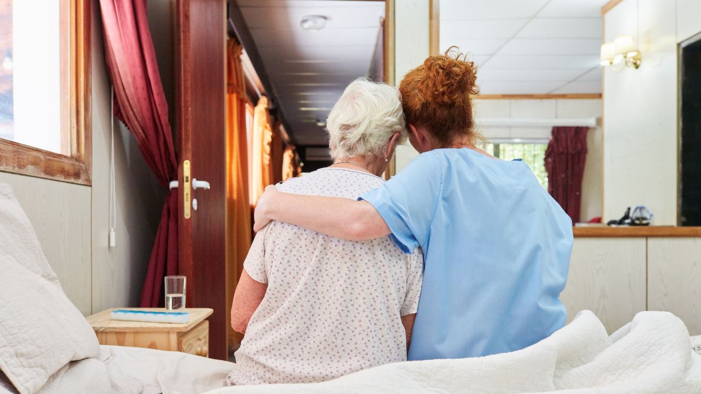 Caregiver comforting a resident in a room