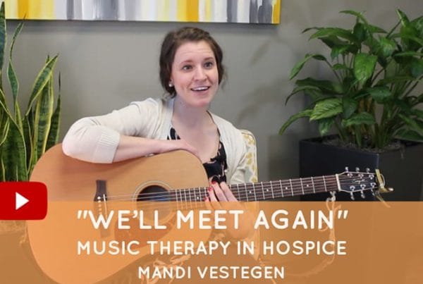 Music therapy session with a smiling staff member.
