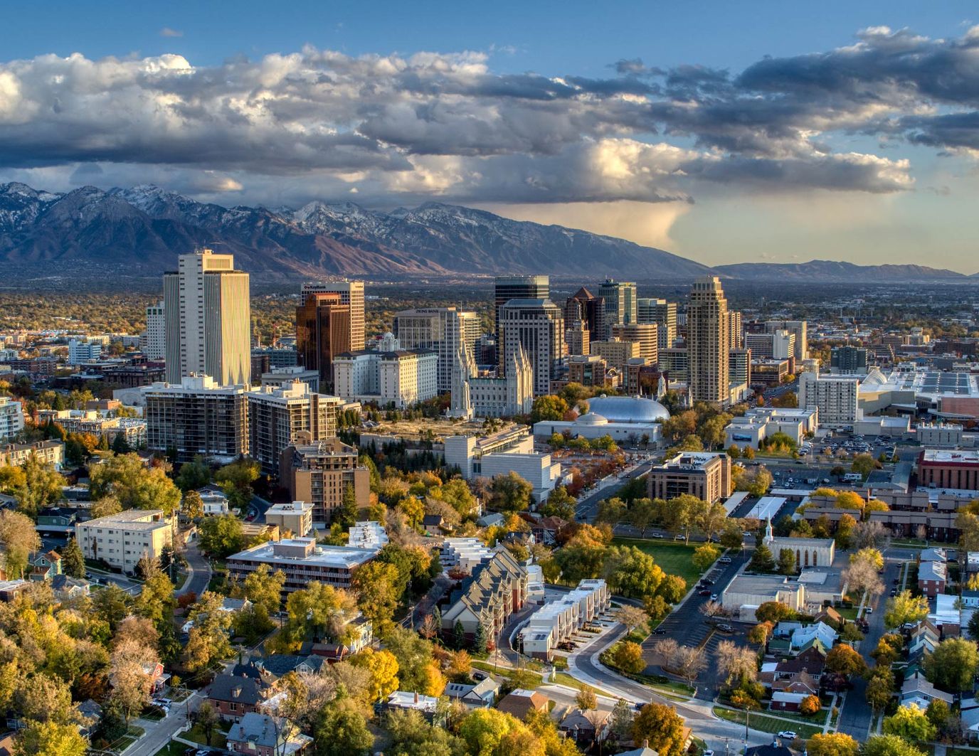 Aerial view of a city skyline with mountains.
