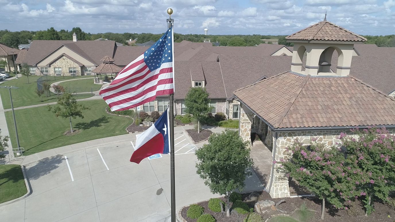 Aerial view of Belterra Health & Rehabilitation building with flags