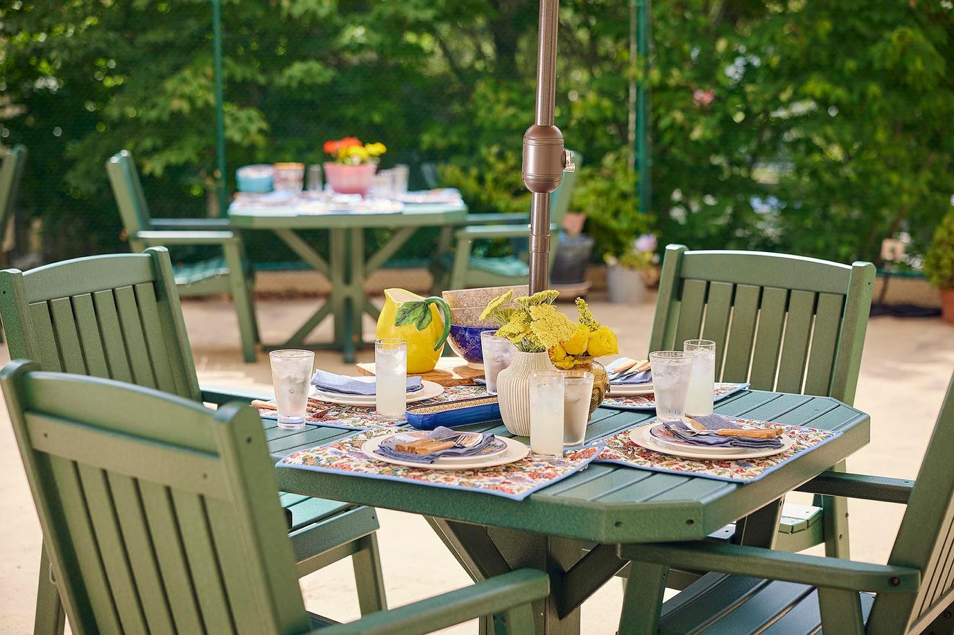 Outdoor dining setup with drinks and meals on the table