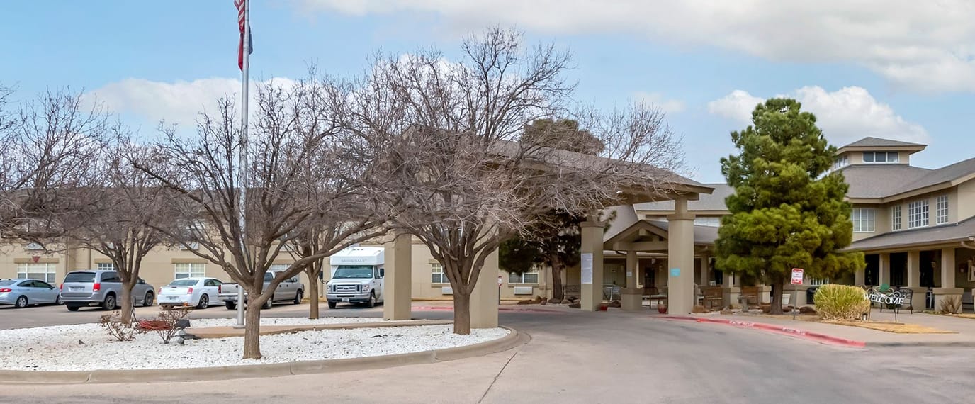 Exterior view of Brookdale Sherwood with entrance and trees