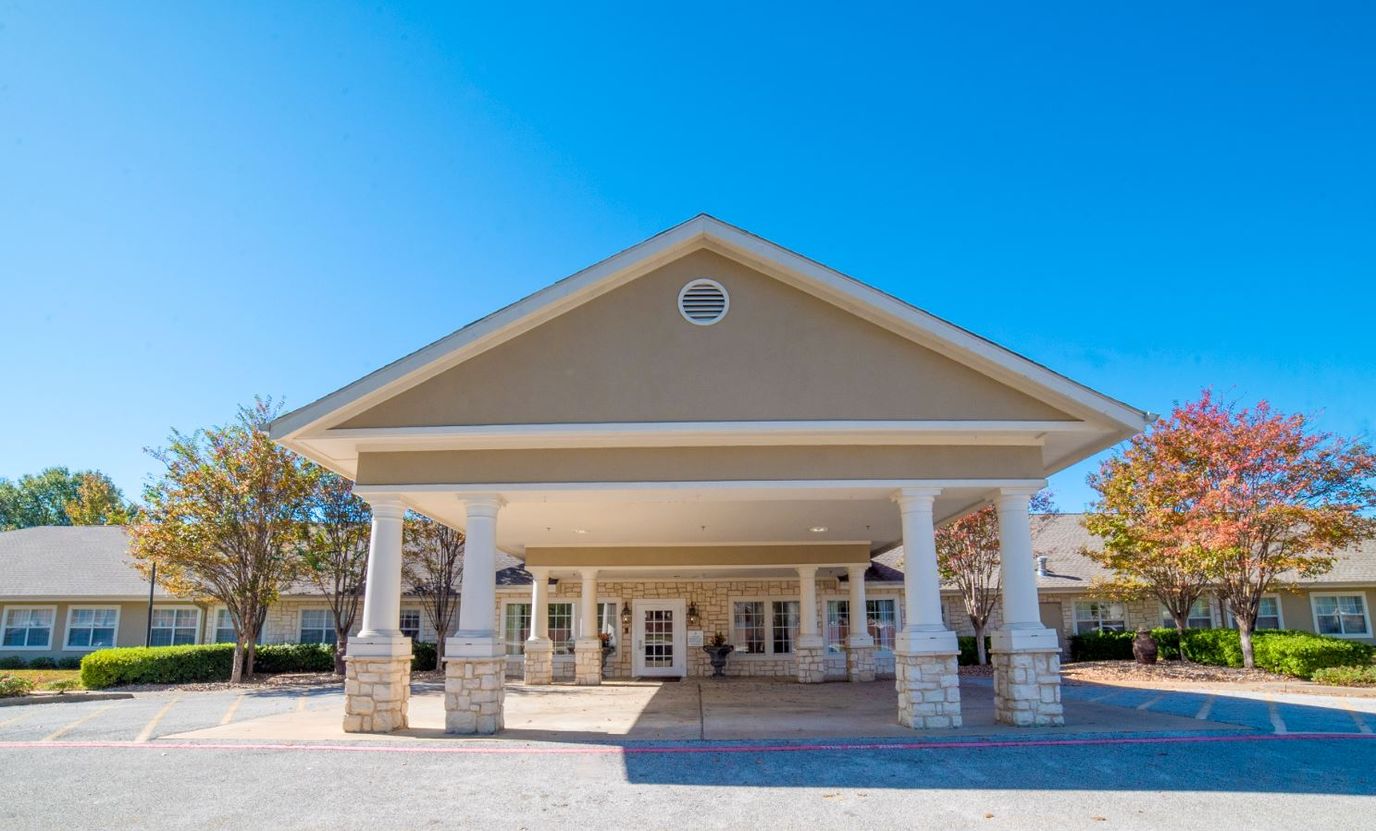 Front entrance of a senior living facility with landscaping