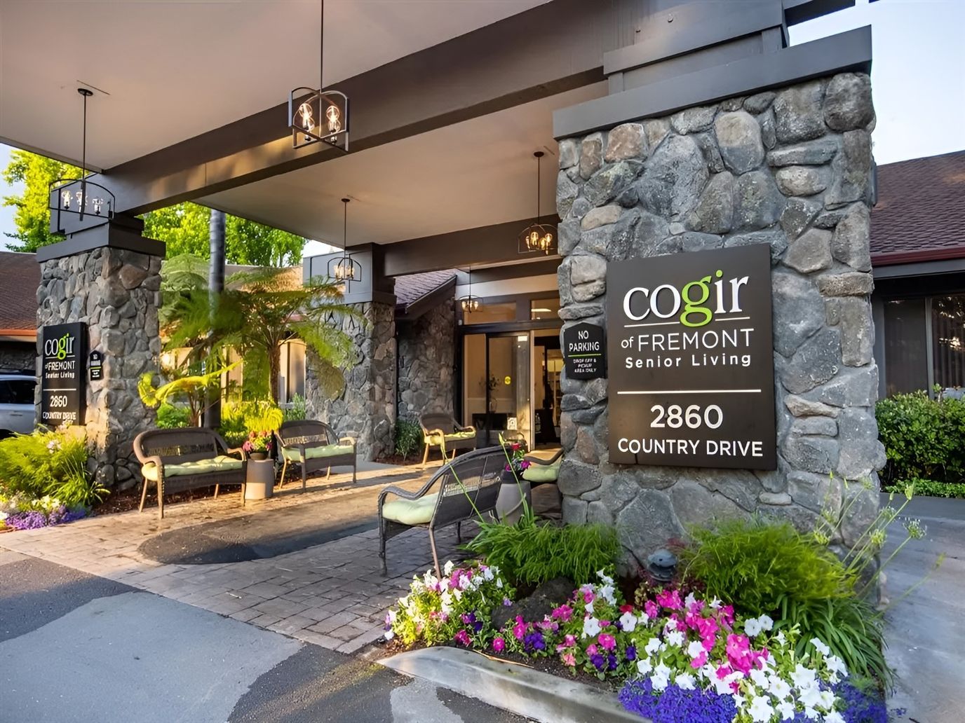 Entrance of Cogir of Fremont Senior Living with floral landscaping