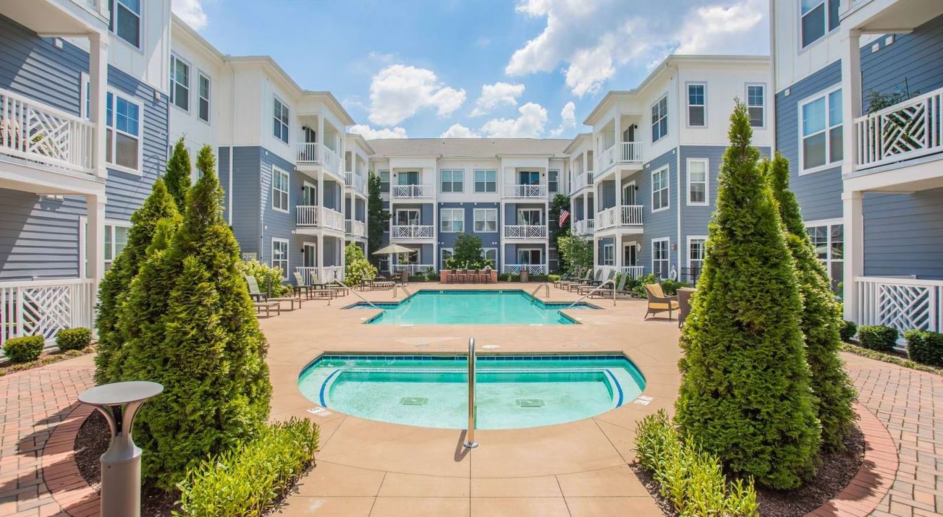 Pool area surrounded by building exteriors and landscaping