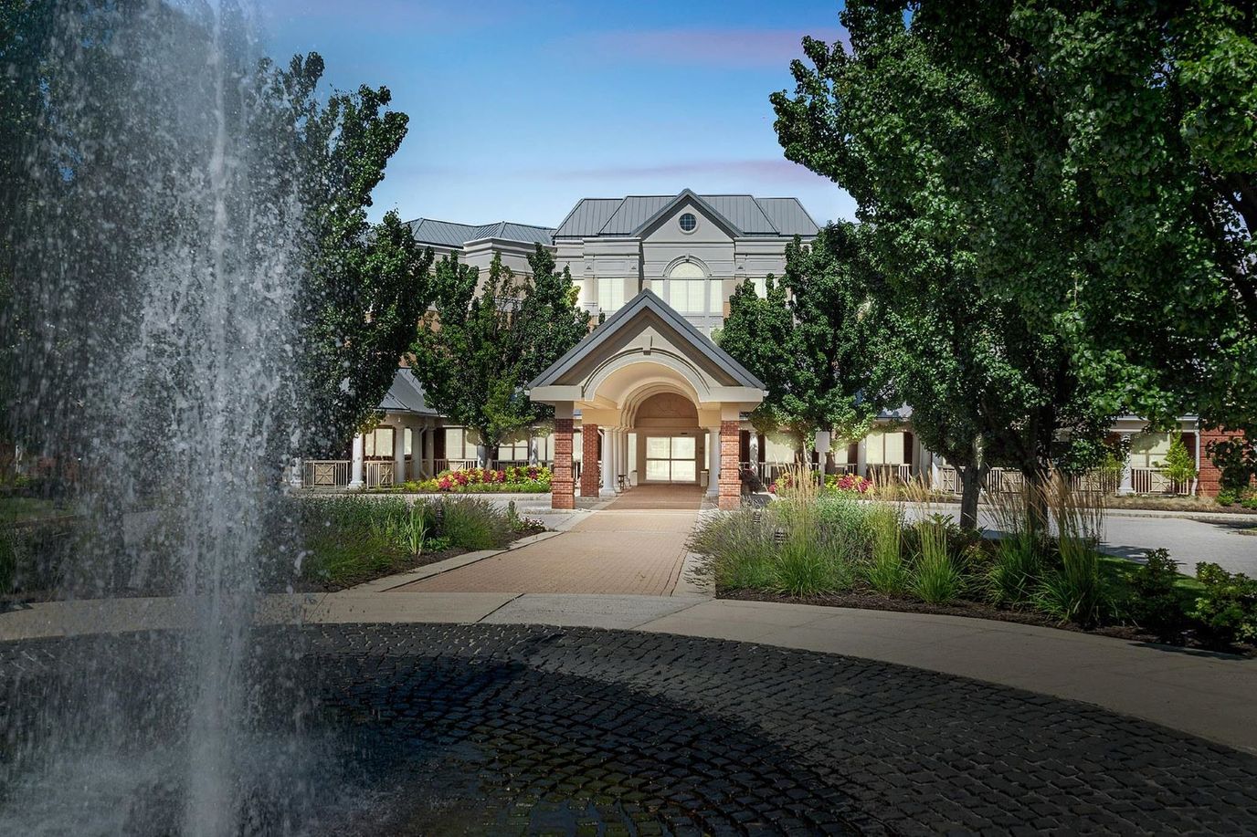 Exterior view of a senior living facility with landscaping