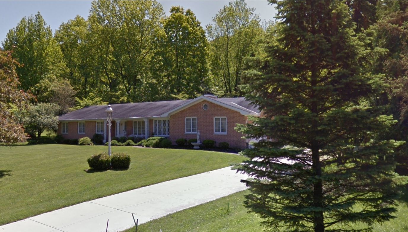 Exterior view of Scott's Place surrounded by greenery