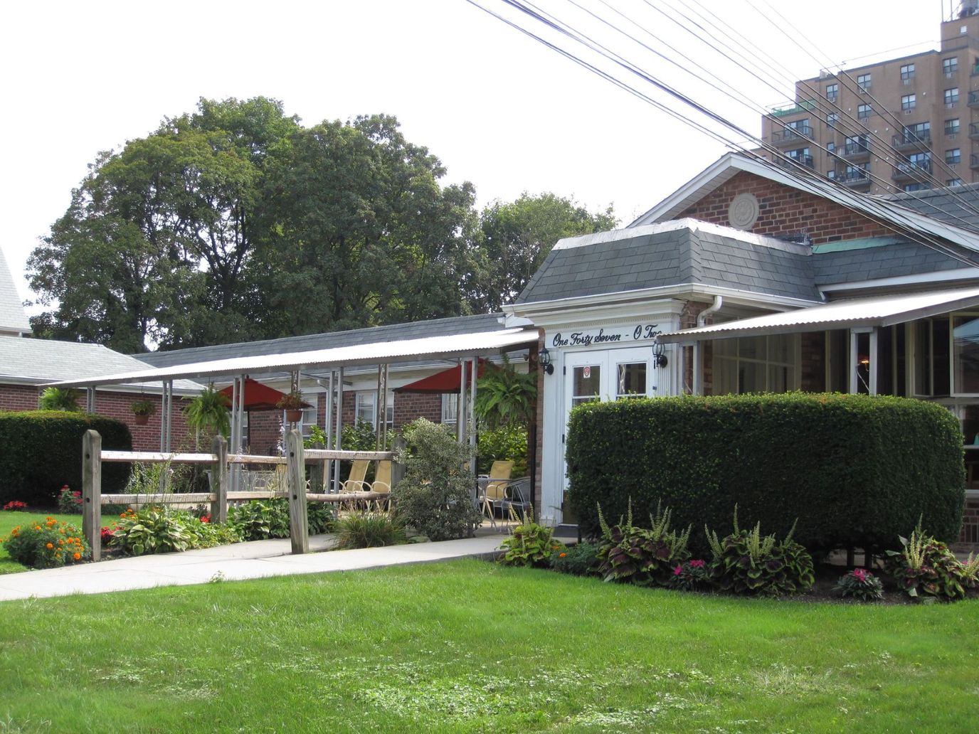 Exterior view of a senior living facility entrance and garden