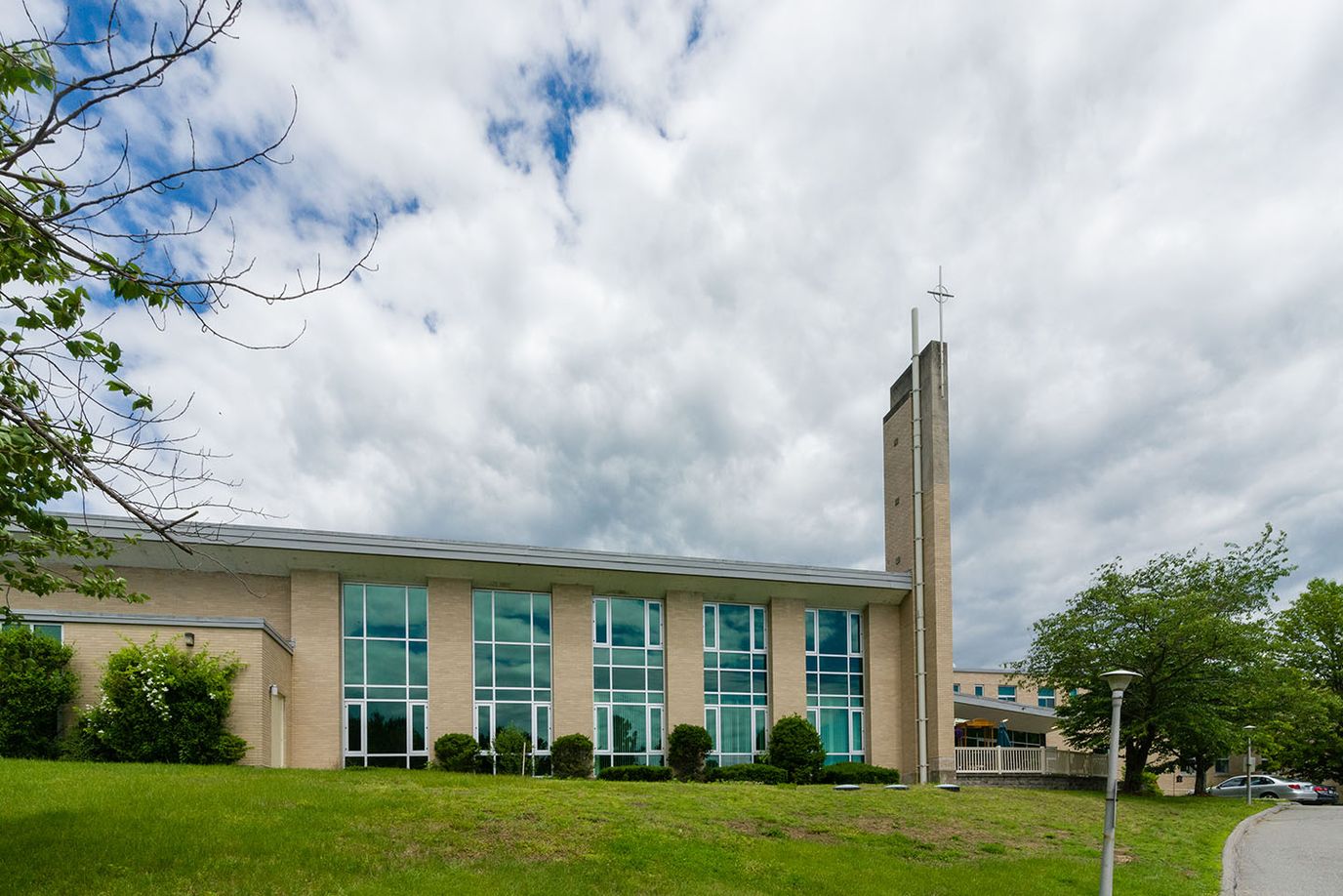 Exterior view of Warde Senior Living building with clouds