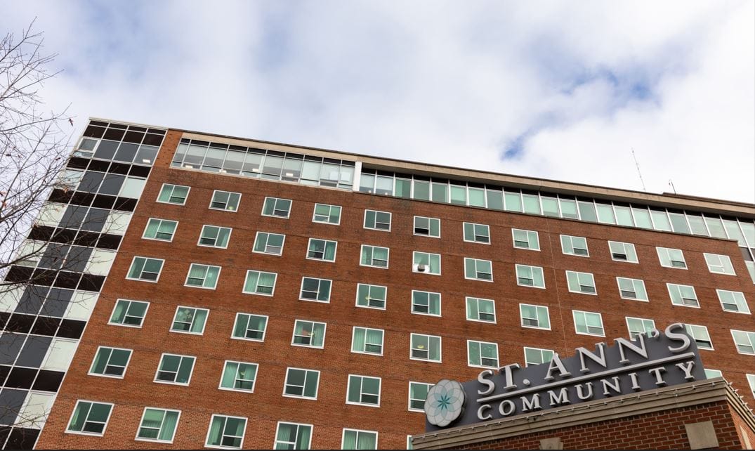 Exterior view of St. Ann's Community building with logo