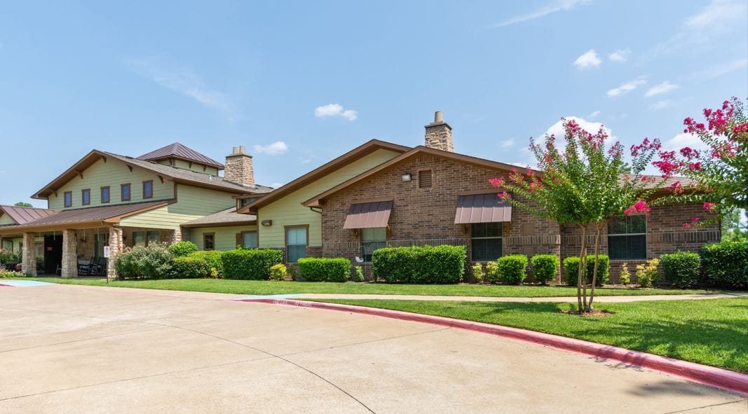 Exterior view of Azalea Trails building with landscaping
