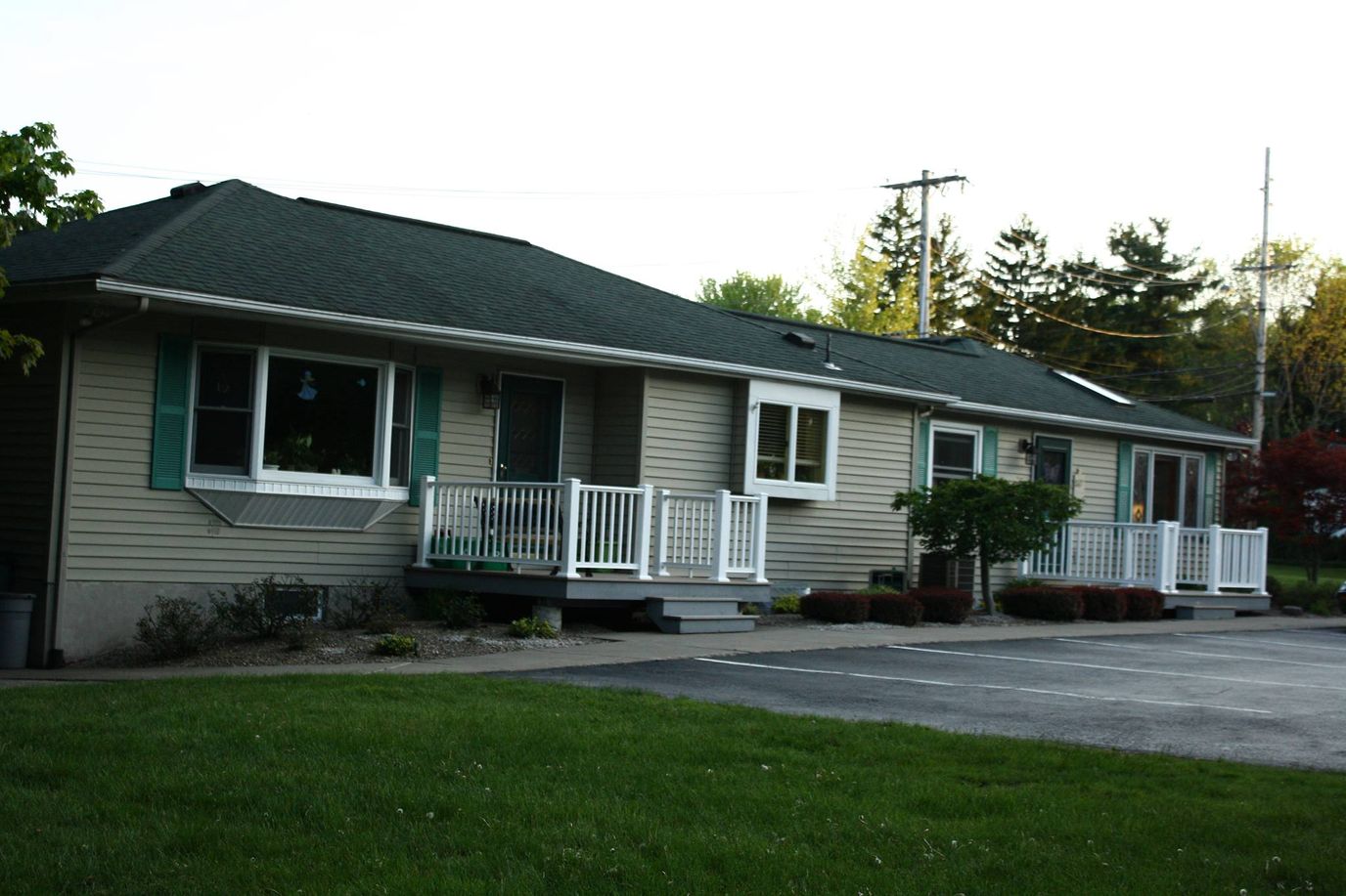 Exterior view of a senior living facility with porches