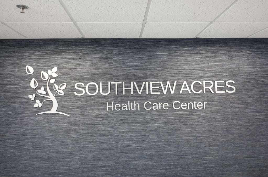 Facility logo on a blue textured wall