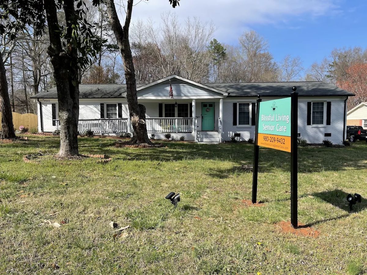 Exterior view of a senior living facility with sign