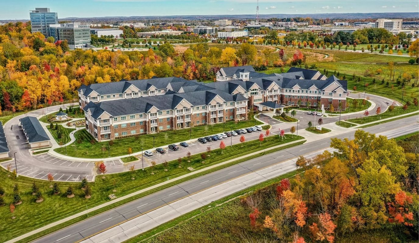 Aerial view of a senior living facility surrounded by colorful trees