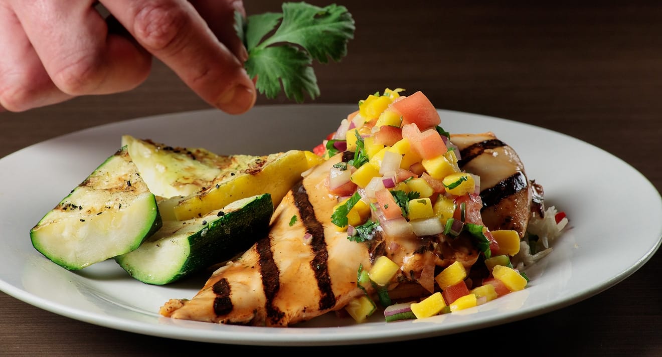 Grilled salmon with mango salsa and vegetables