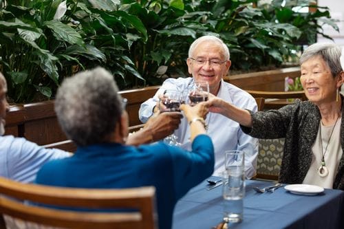 Carol Woods, Nursing Home in Chapel Hill, NC — Seniors toasting with glasses of wine at a dining table
