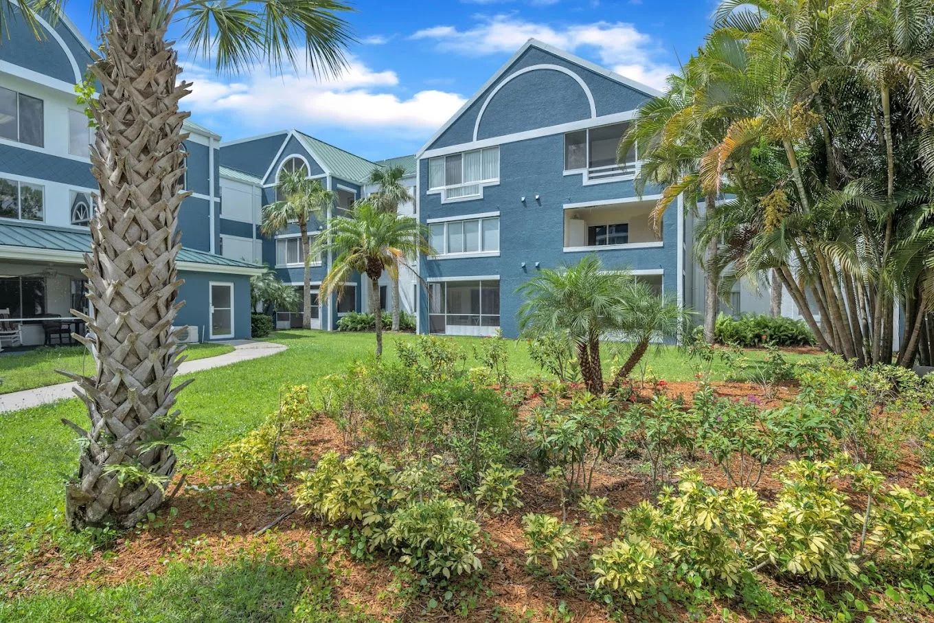 Exterior view of Discovery Village Vero Beach with landscaped gardens