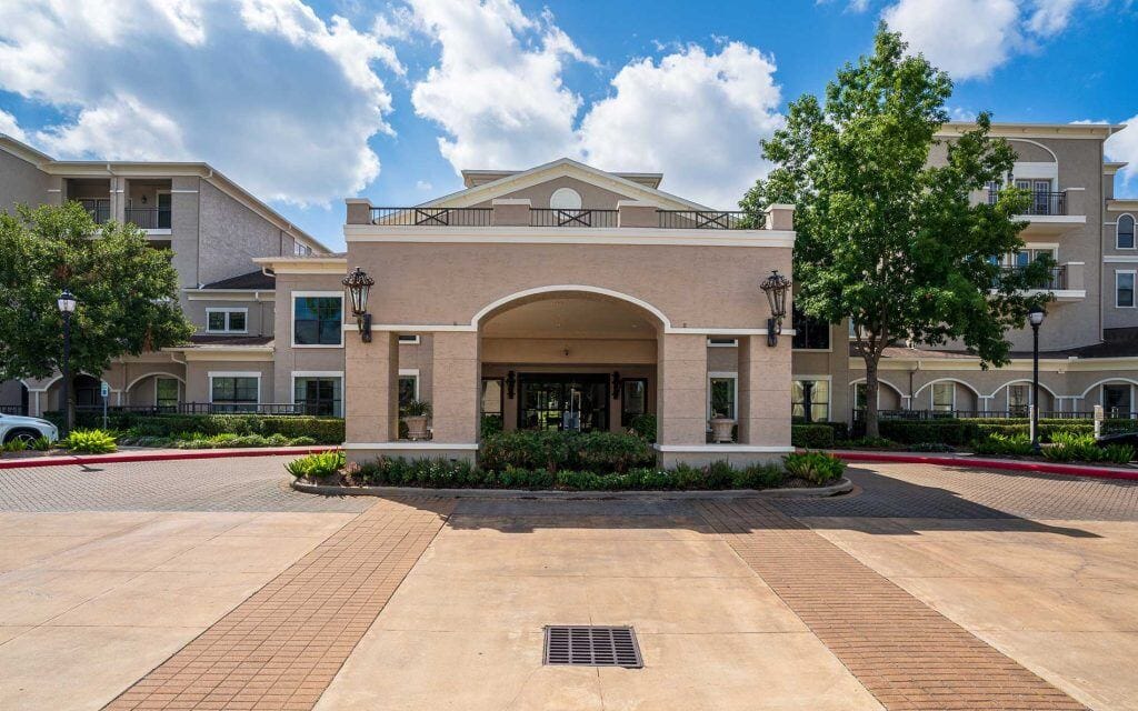 Conservatory at Champion Forest, independent living in Spring, TX — Entrance of a senior living facility with landscaping