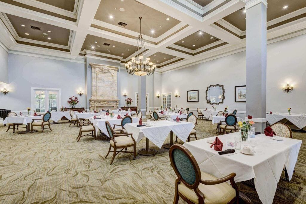 Conservatory at Champion Forest, independent living in Spring, TX — Elegant dining room with tables set for meals