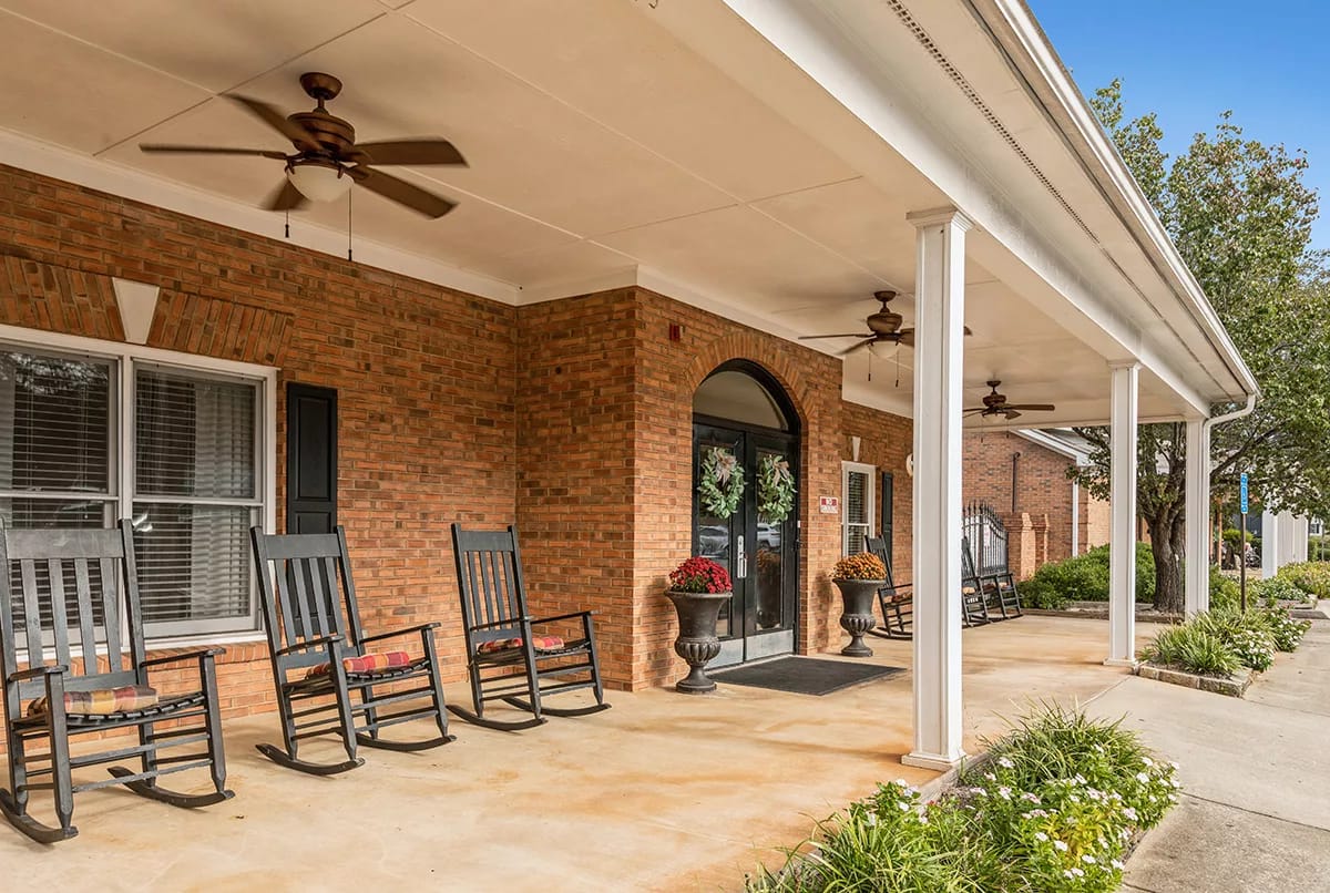 Entryway of a senior living facility with rocking chairs
