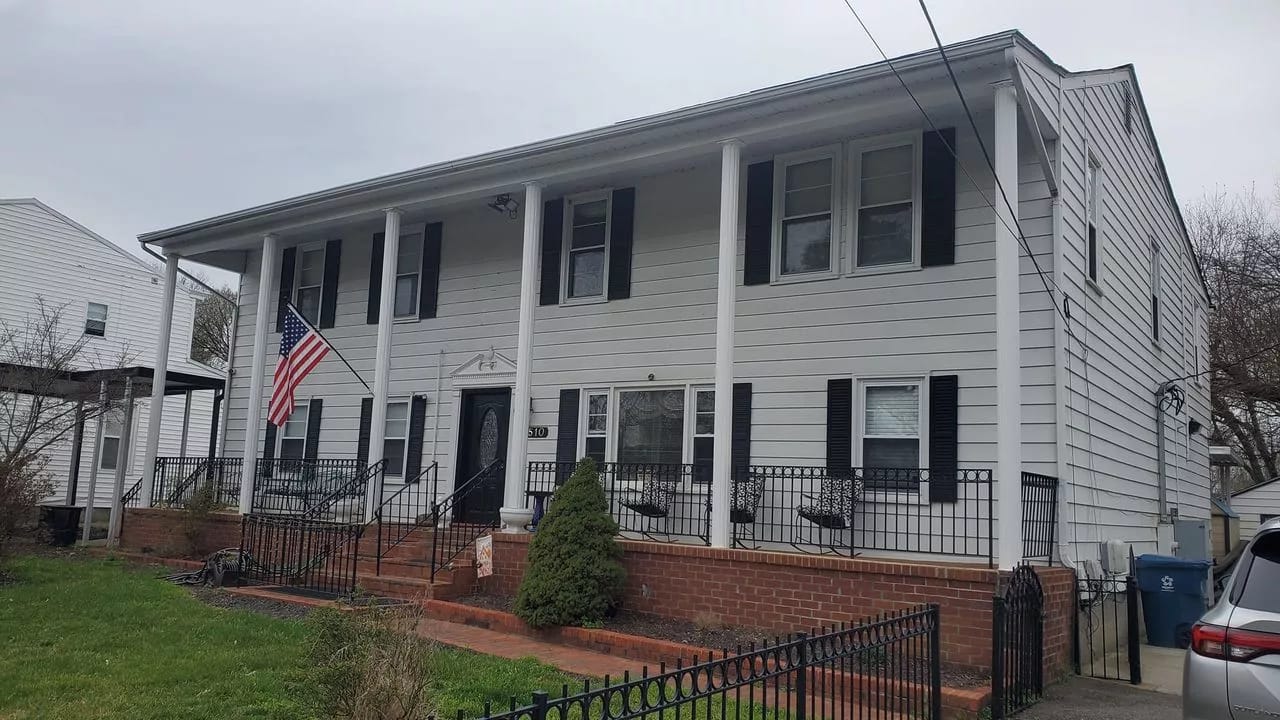 Exterior view of a senior living facility with an American flag