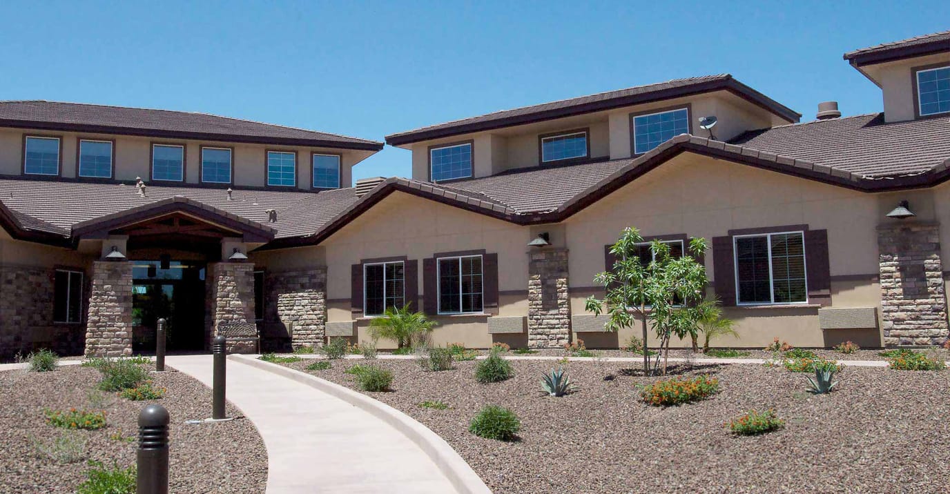 Exterior view of a senior living facility with landscaping