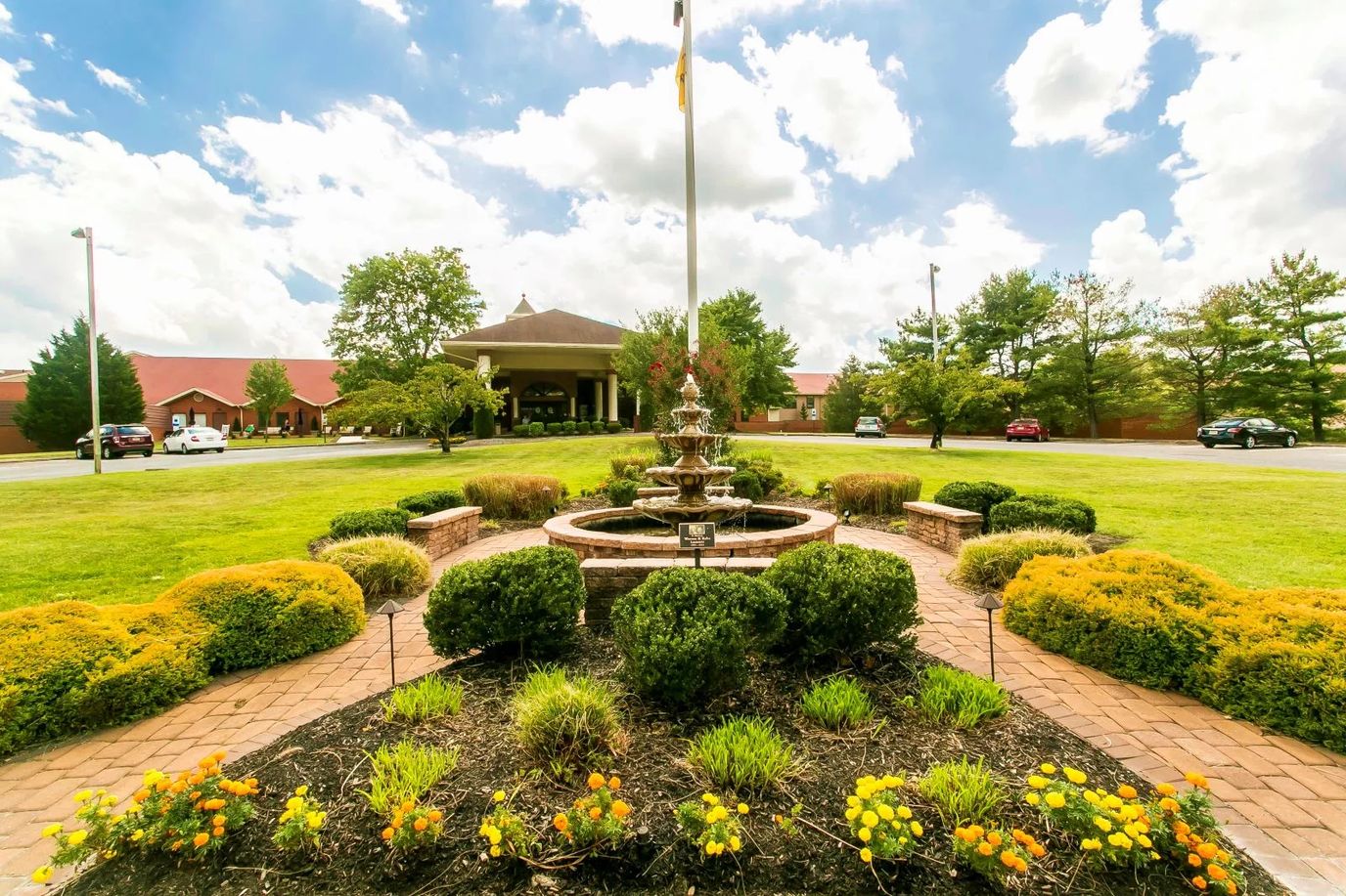 Outdoor view of the facility entrance with fountain and landscaping