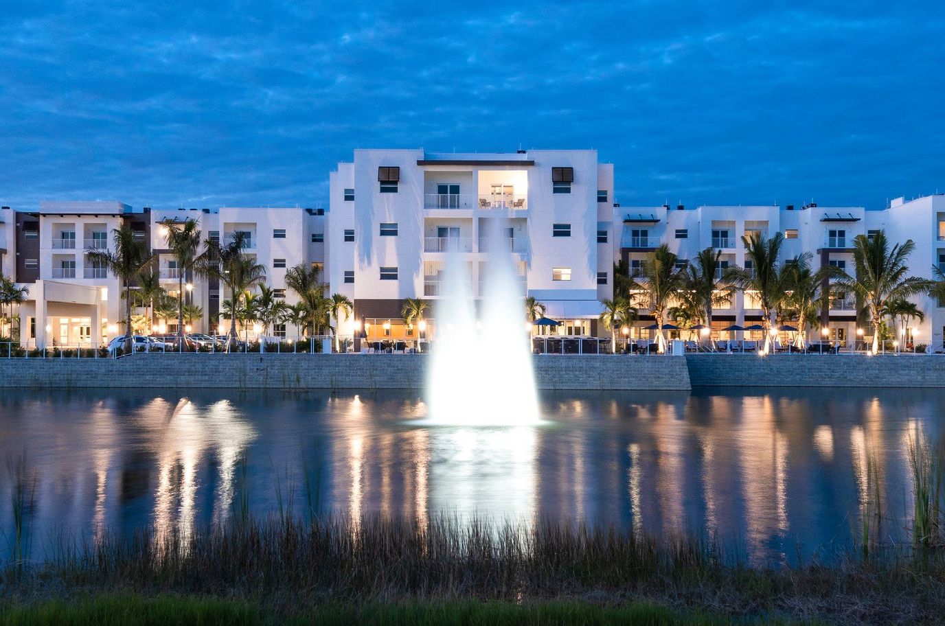 Exterior view of a modern assisted living facility at dusk