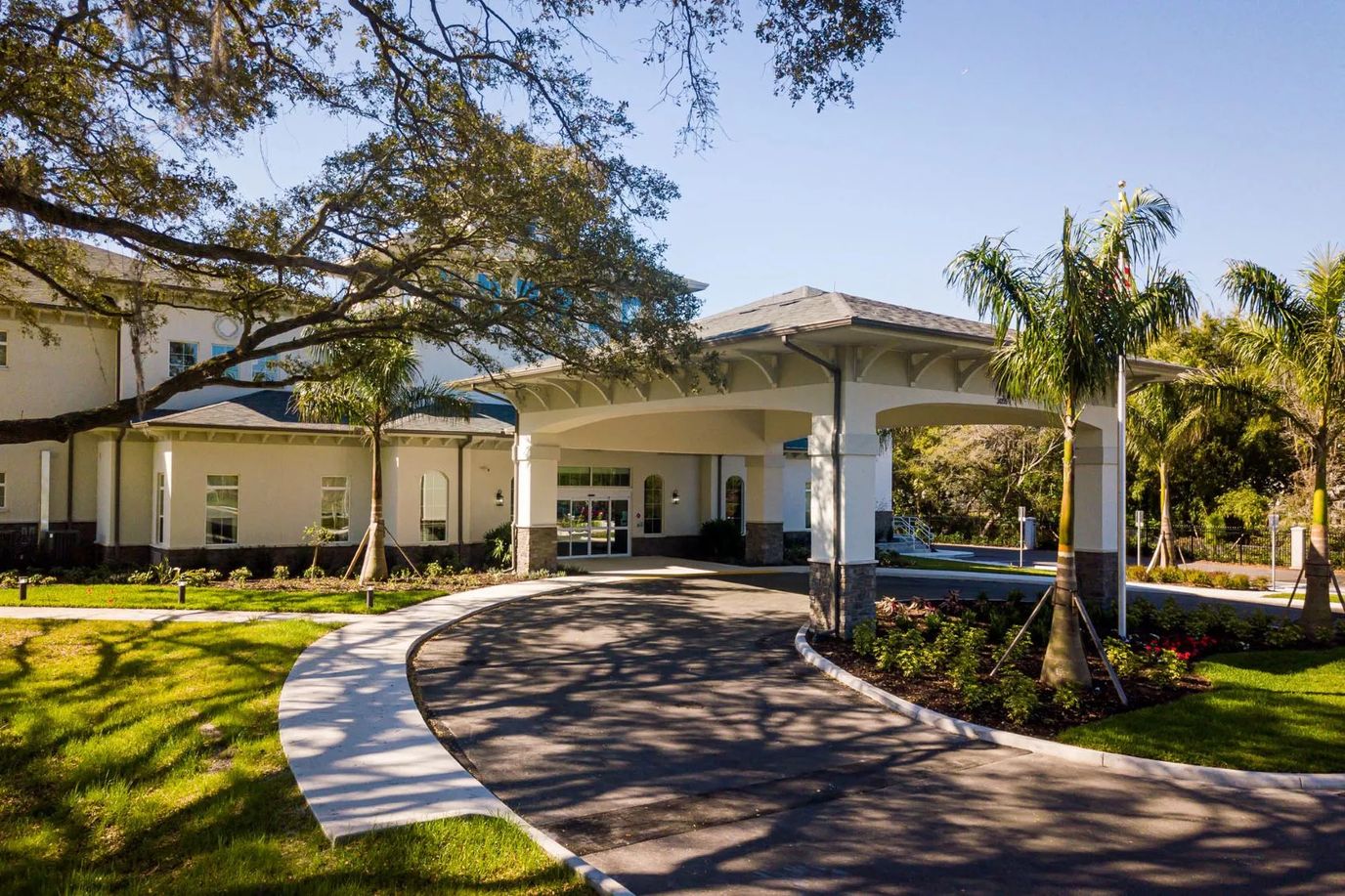 Front entrance of a senior living facility with landscaped grounds