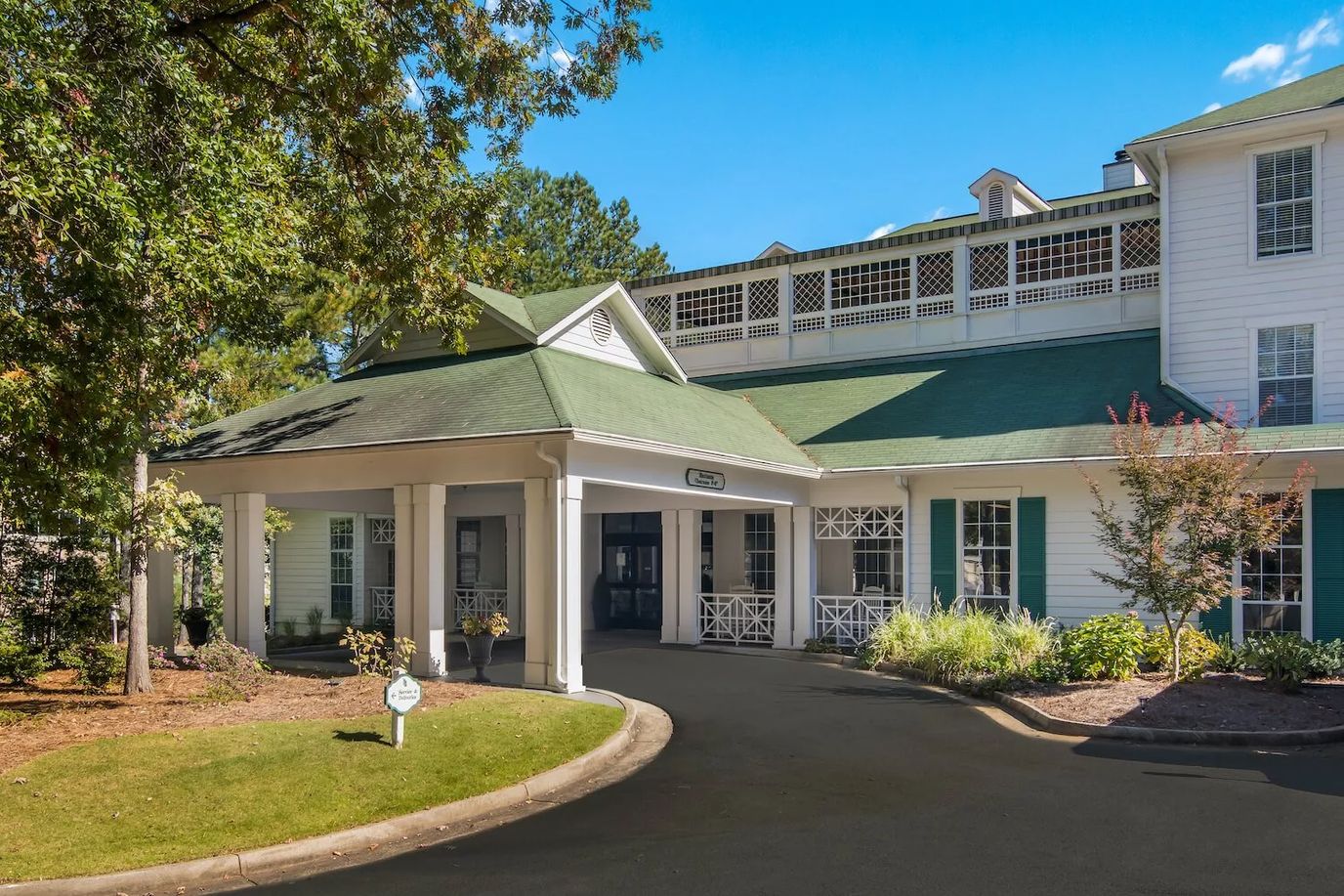 Exterior view of a senior living facility with a covered entrance