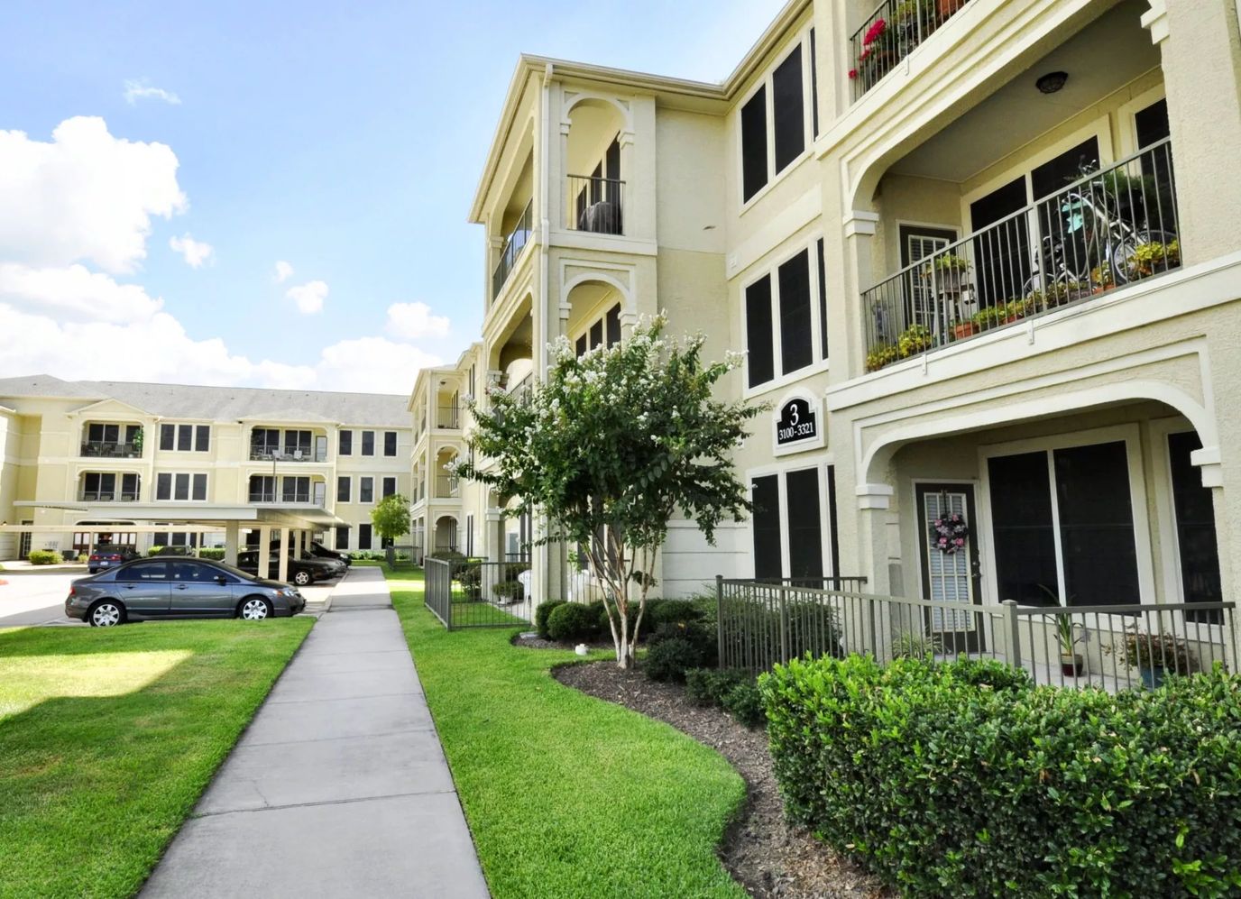 Exterior view of a senior living facility with landscaped walkways