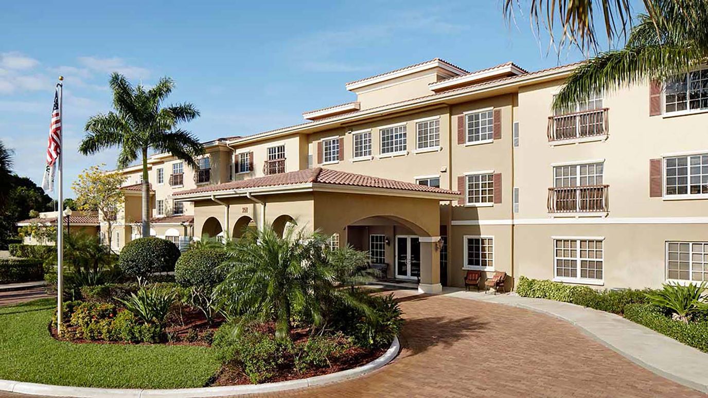 Exterior view of a senior living facility with landscaping