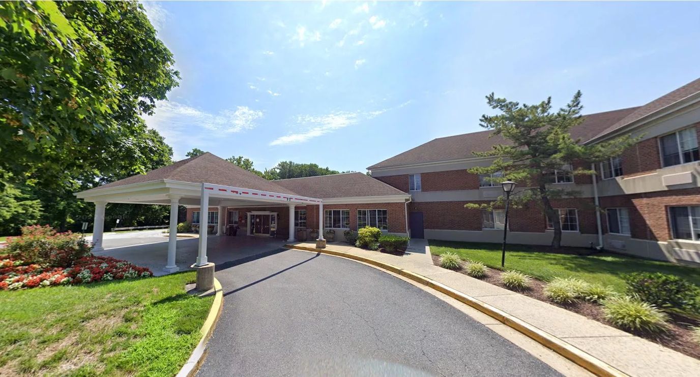 Entrance view of a senior living facility with landscaping