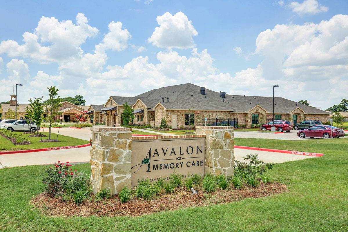 Exterior view of Avalon Memory Care with landscaping