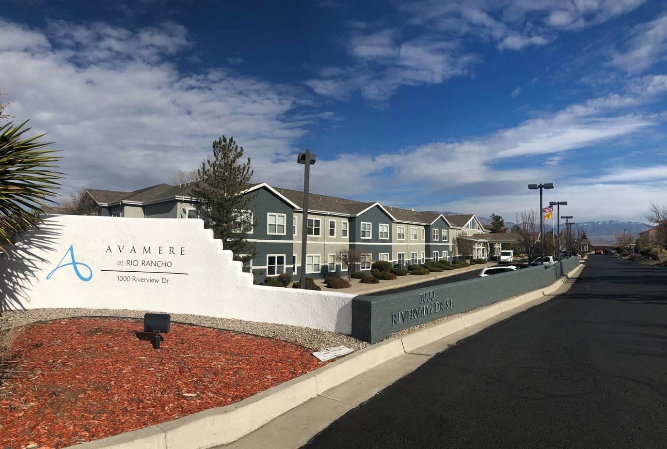 Exterior view of a senior living facility with landscaping