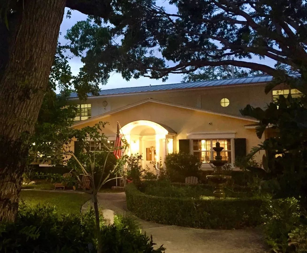 Front entrance of the Bay Oaks Historic Retirement Residence at dusk