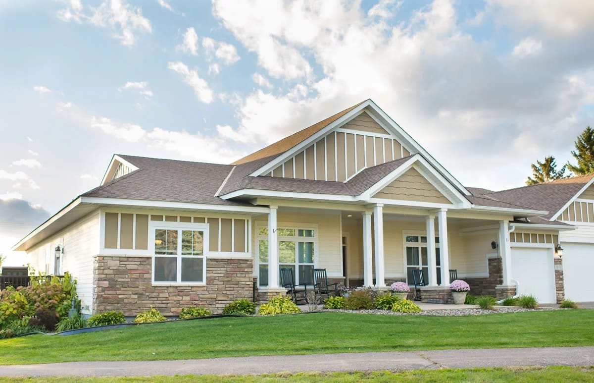 Exterior view of a senior living facility with lush landscaping