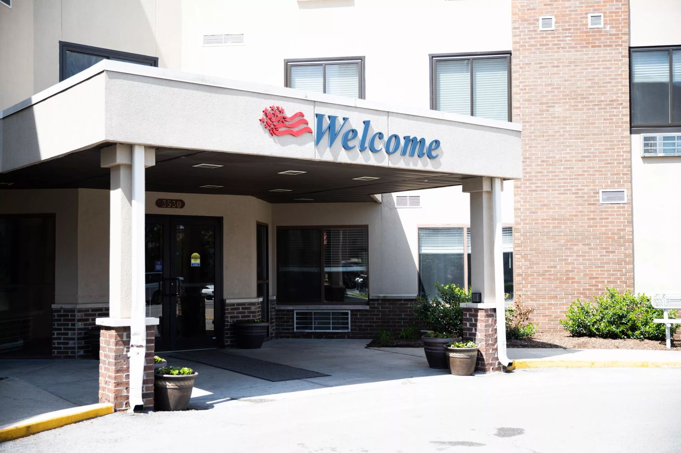 Entrance of a senior living facility with a welcome sign
