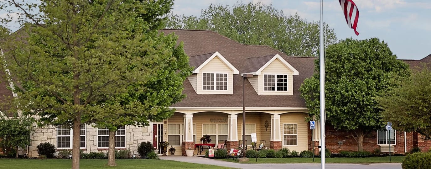 Exterior view of a senior living facility with landscaped grounds