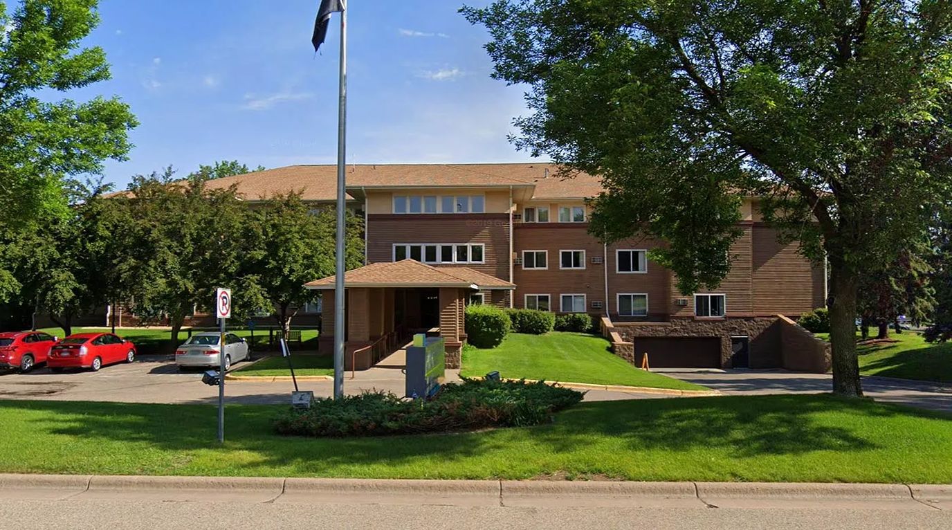 Exterior view of a senior living facility with landscaping
