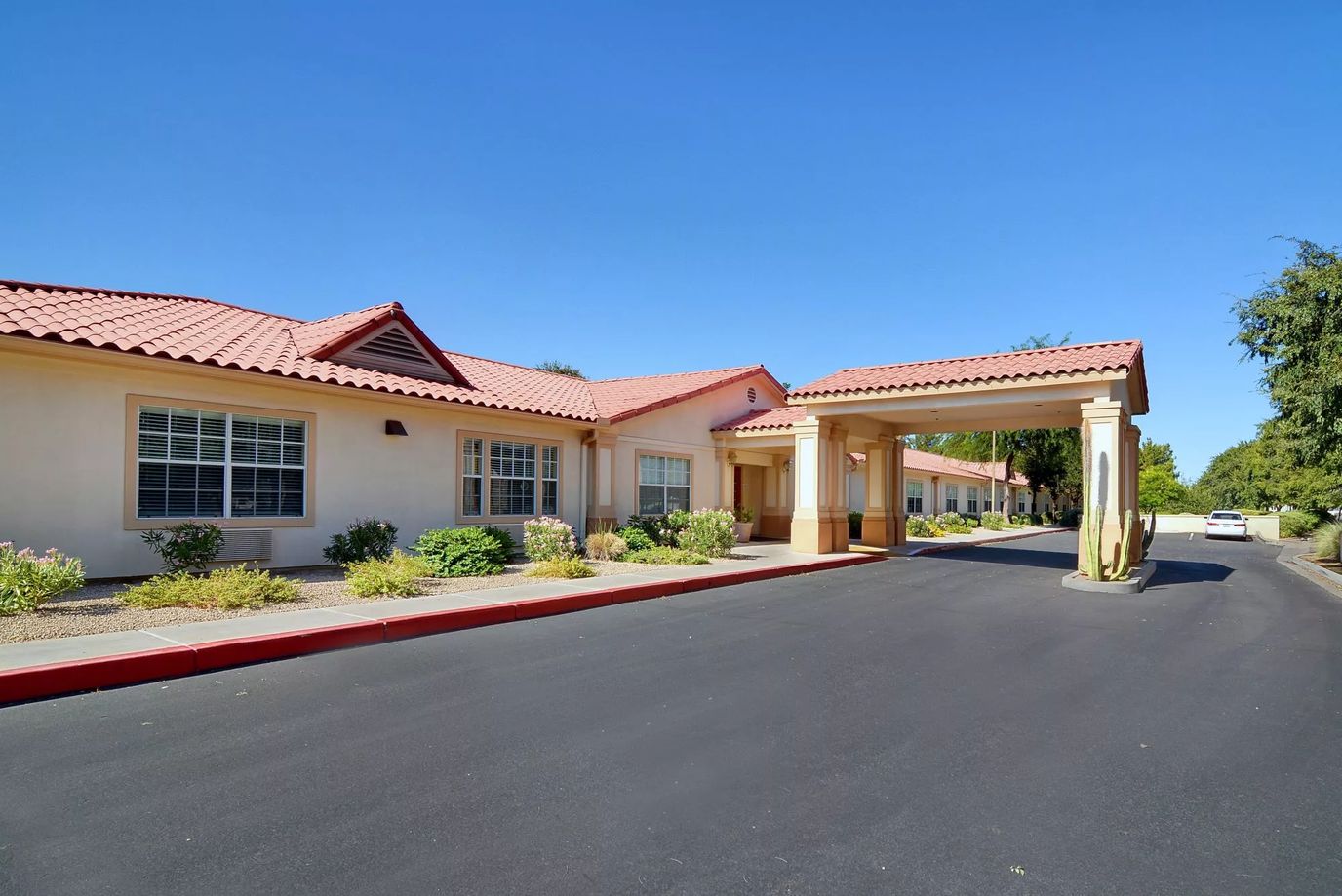 Exterior view of a senior living facility with gardens