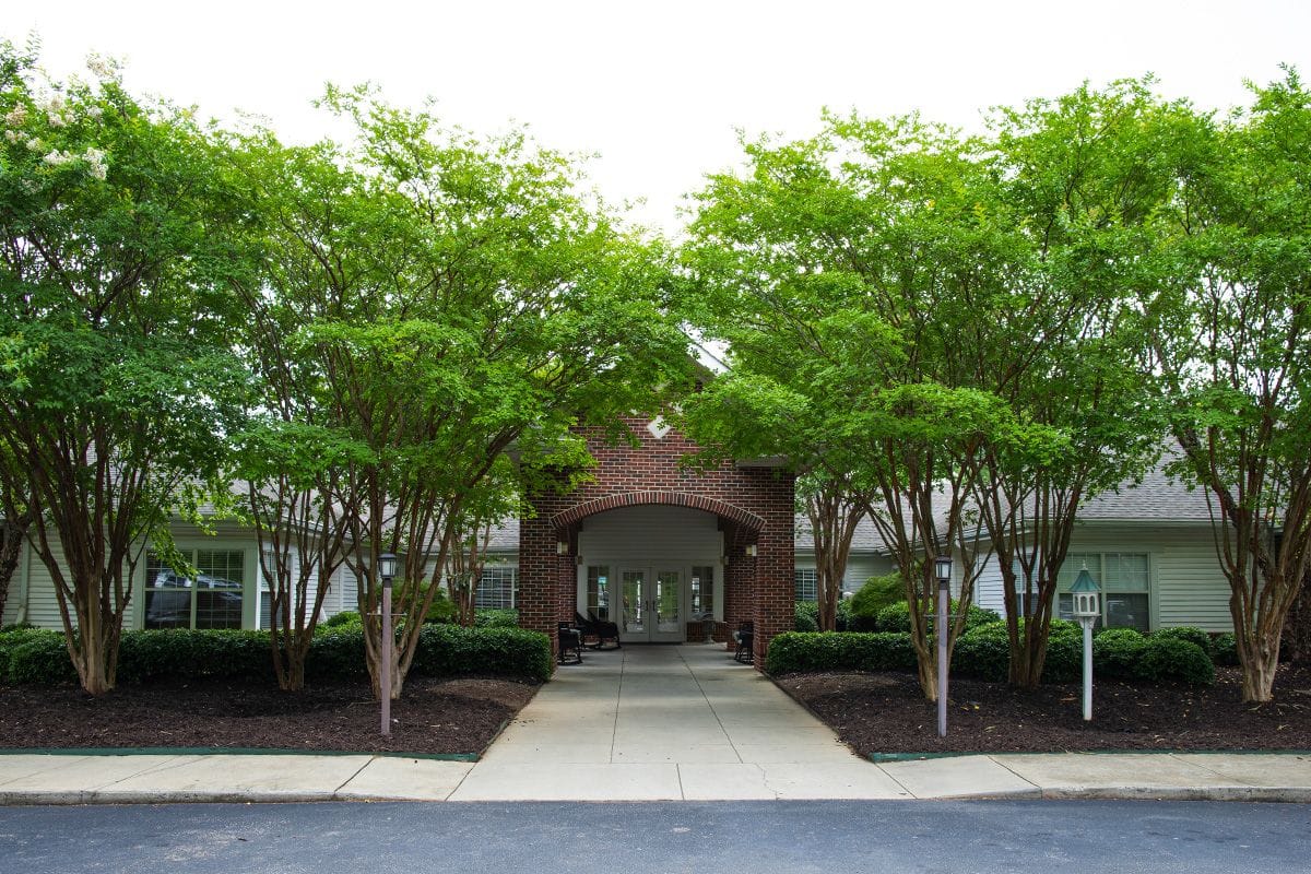 Entrance of the facility surrounded by greenery