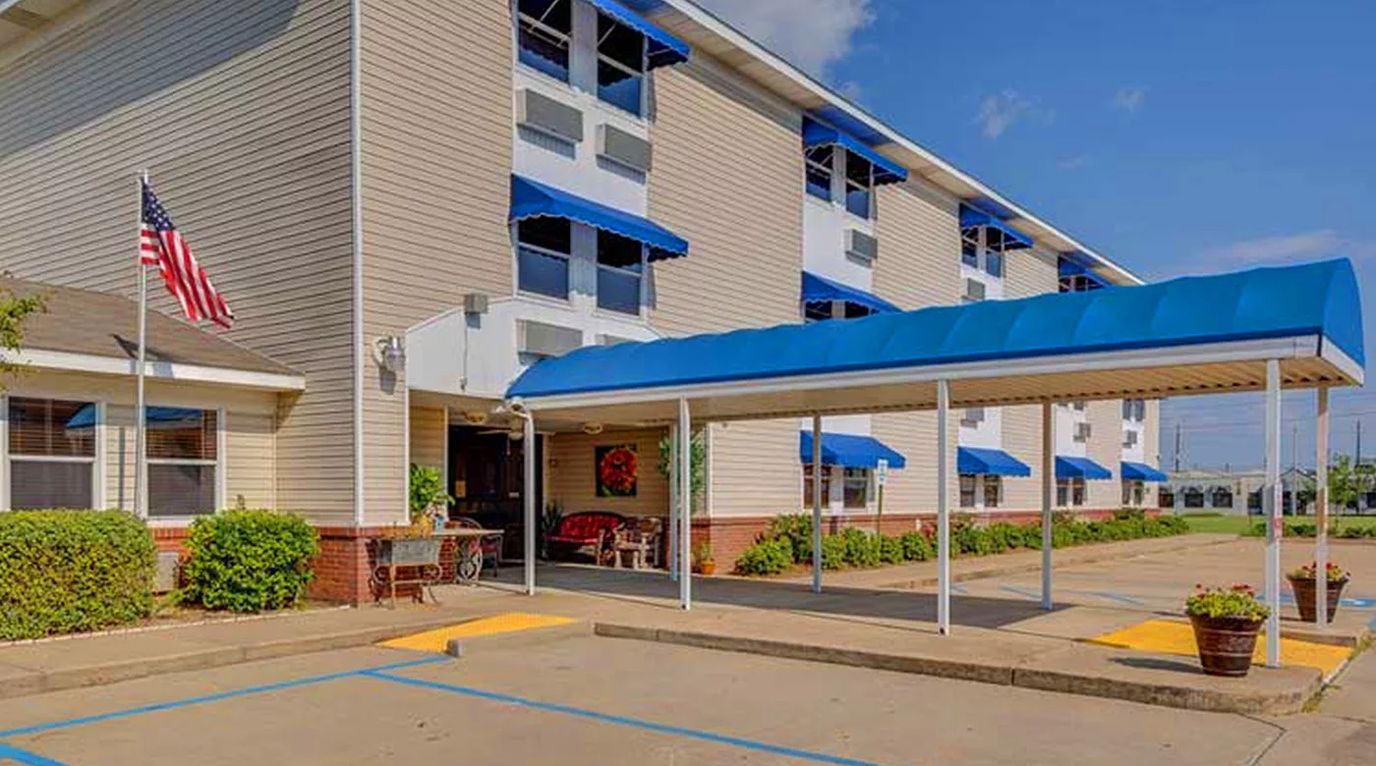 Front entrance and canopy of the facility with blue awnings